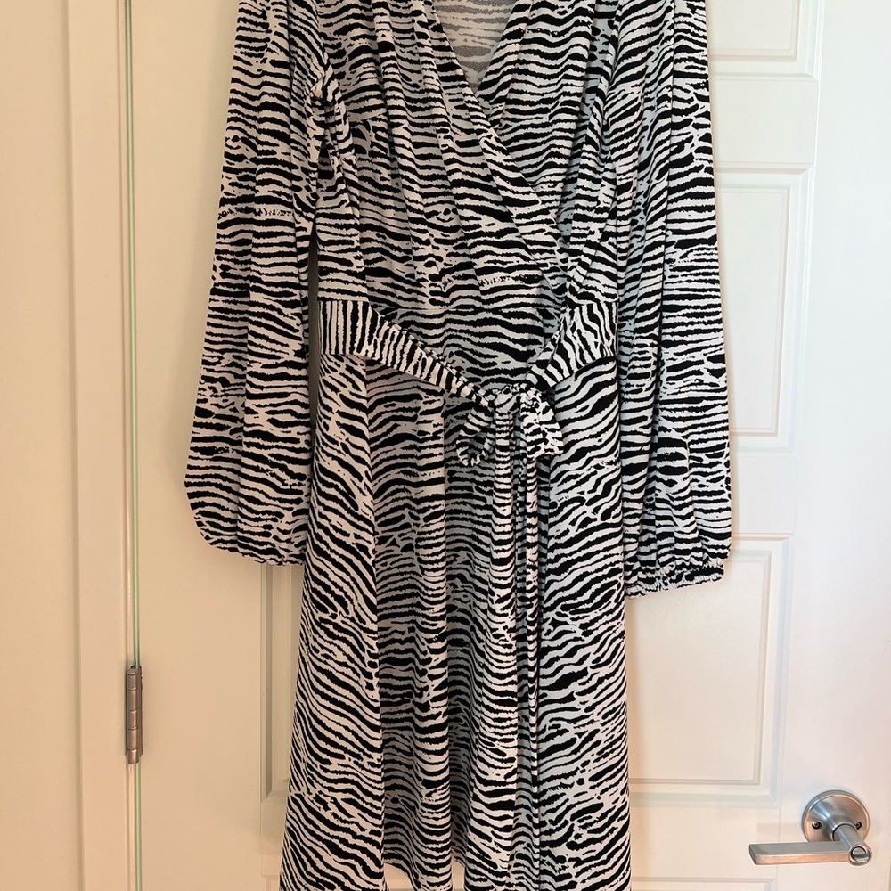 Zebra print dress, flexible material and molds to body shape very flattering.